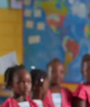Pupils in uniform listening in a classroom